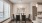 a room with a table chairs and a painting on the wall
