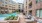 a pool and chairs outside a building