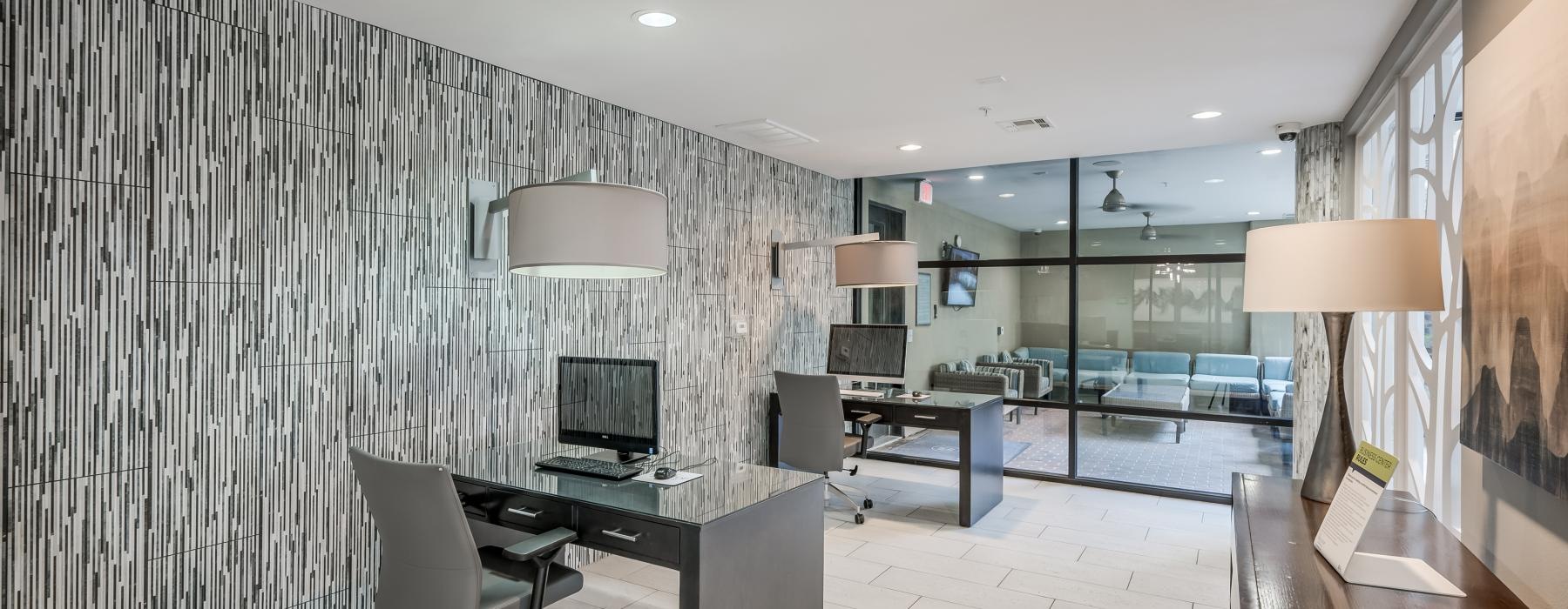 a room with a desk and chairs