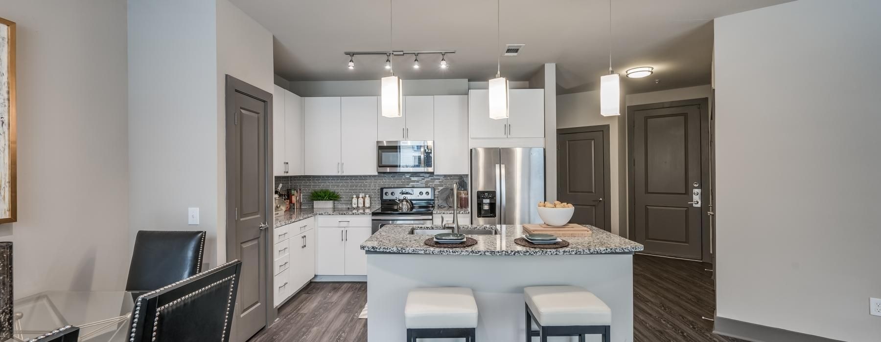 a kitchen with a table and chairs