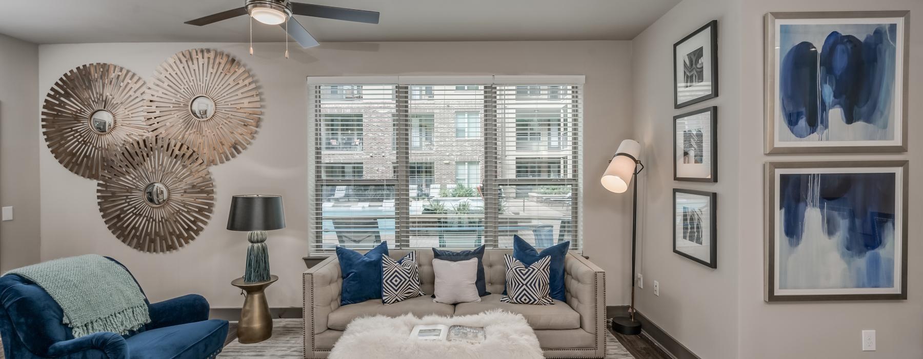 a living room with a couch and a fan