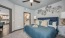 a bedroom with a bed and a fan