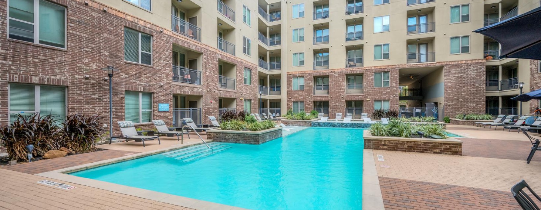 a swimming pool in a courtyard between buildings
