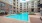 a swimming pool in a courtyard between buildings