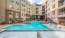a pool in a courtyard between buildings